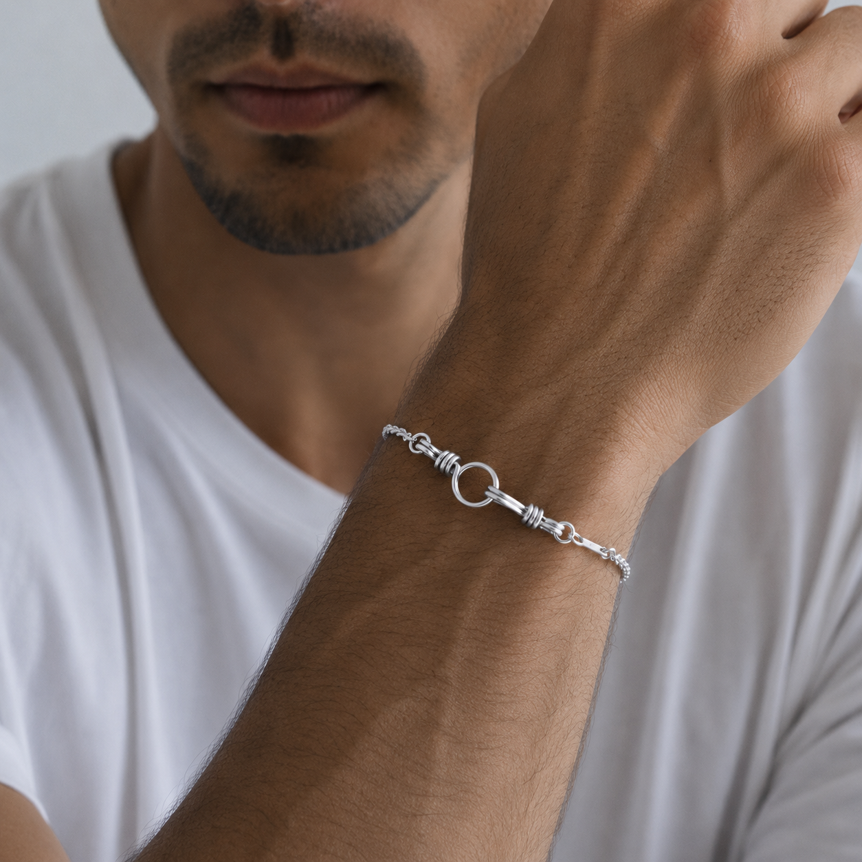 Man wearing a fine silver chain bracelet with a hook attachment as centre piece - Atelier Paulin men's jewellery