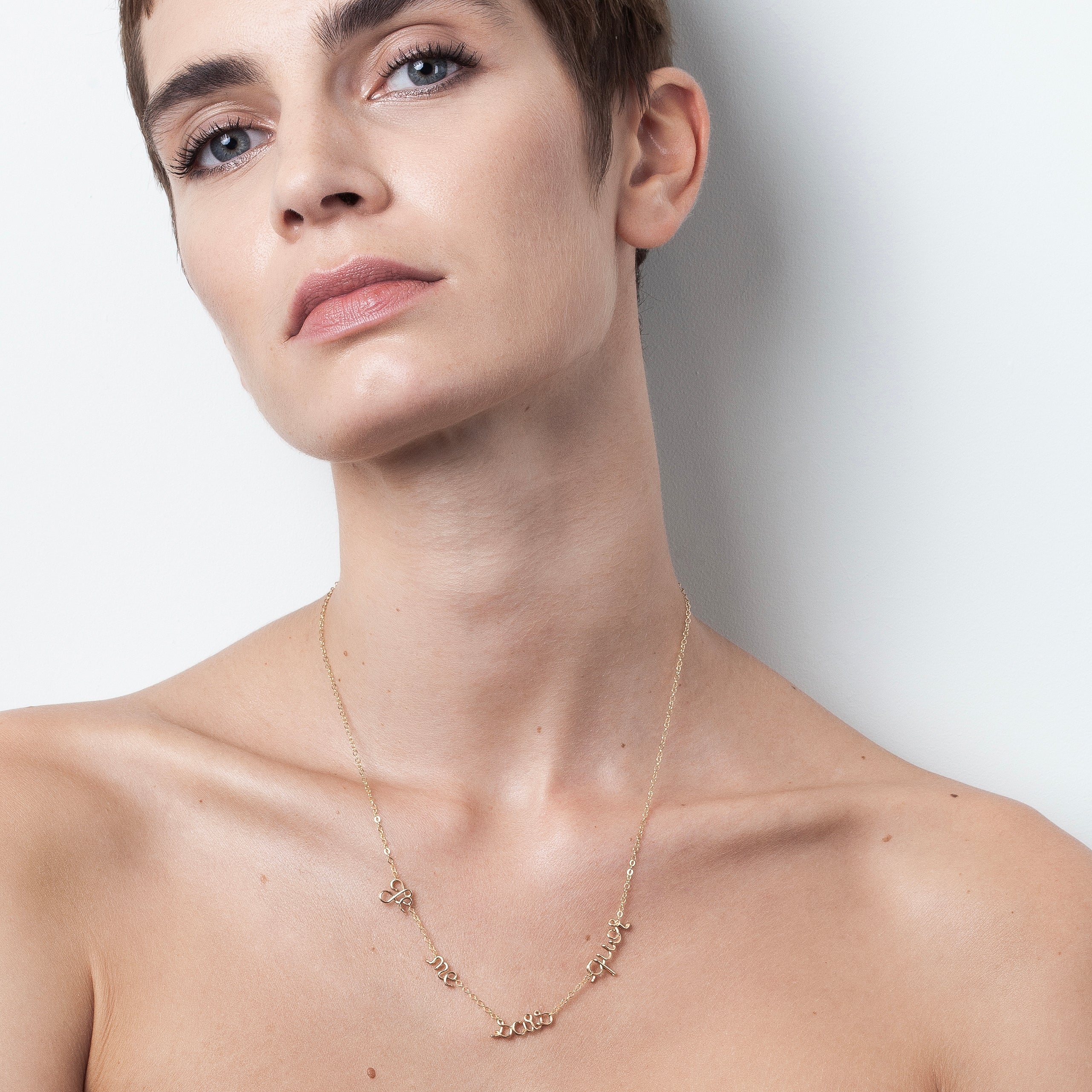 Mantra necklace multiple names personalised on chain yellow gold worn on neck Atelier Paulin Australia