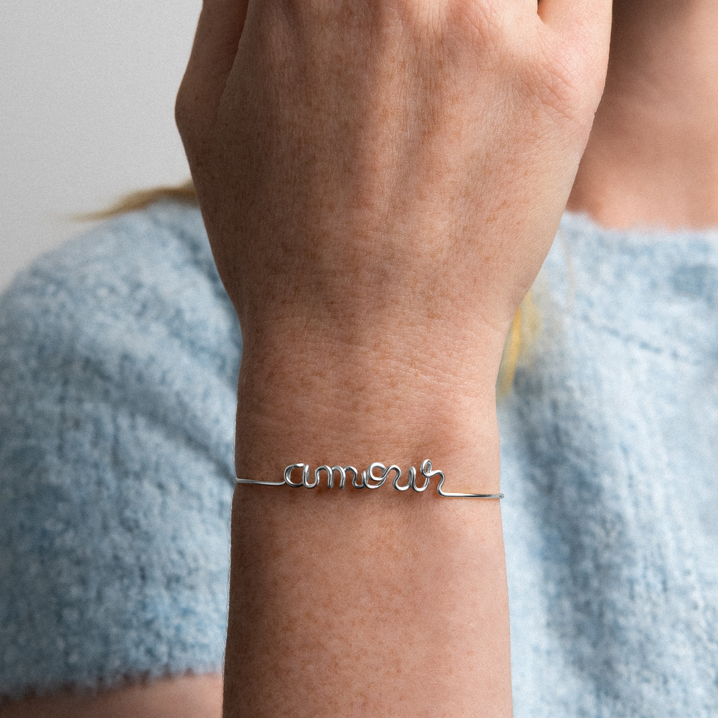 Original bracelet with word Amour silver gold-filled worn on finger handcrafted Atelier Paulin Australia