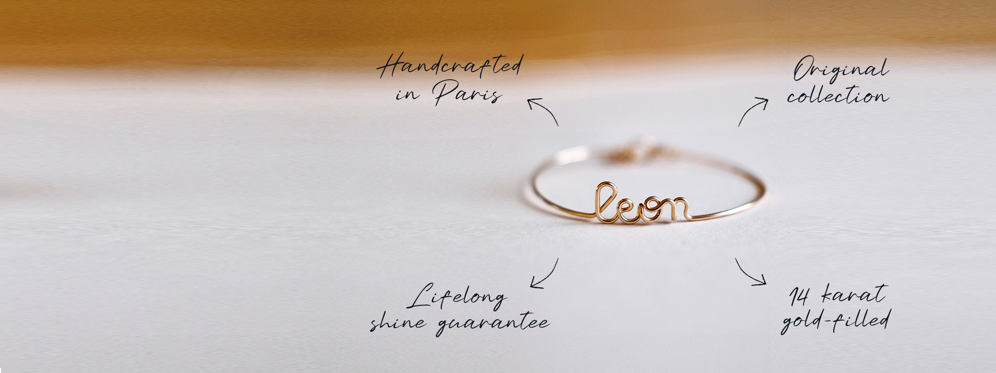 Atelier Paulin Gold bracelet personalised with 'Leon' letters on a light background.