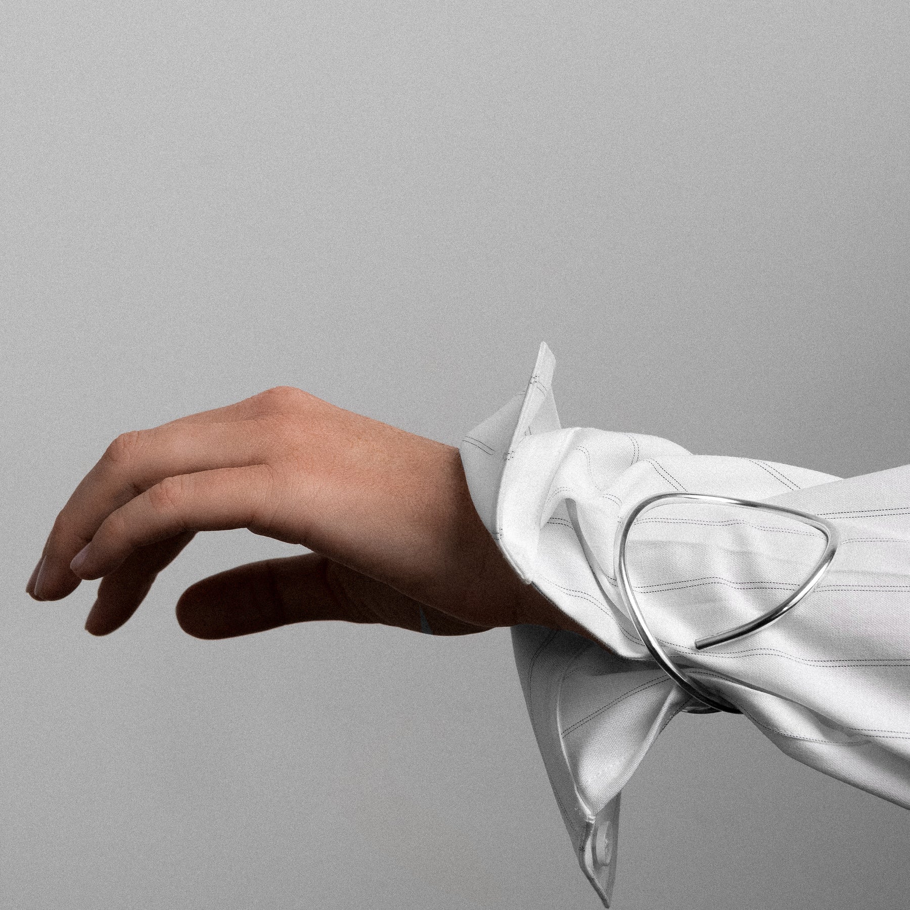 Outline cuff bracelet letter e silver worn over shirt handmade Atelier Paulin Australia